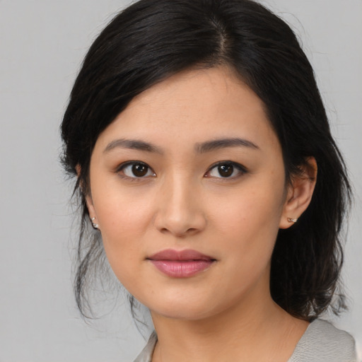 Joyful asian young-adult female with medium  black hair and brown eyes