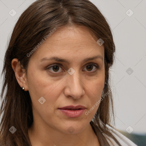 Joyful white adult female with long  brown hair and brown eyes