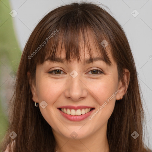 Joyful white adult female with long  brown hair and brown eyes