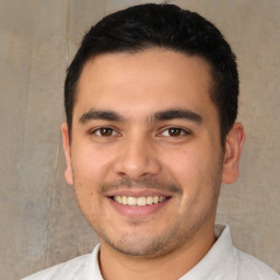 Joyful white young-adult male with short  black hair and brown eyes