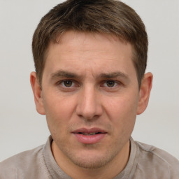 Joyful white adult male with short  brown hair and grey eyes