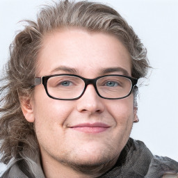 Joyful white adult male with short  brown hair and blue eyes