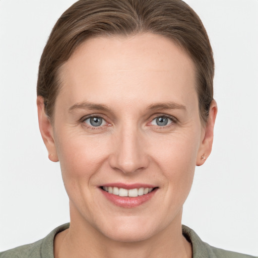 Joyful white adult female with short  brown hair and grey eyes