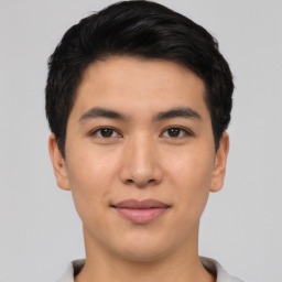 Joyful asian young-adult male with short  black hair and brown eyes