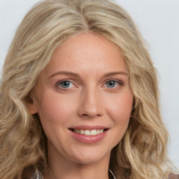 Joyful white young-adult female with long  brown hair and blue eyes