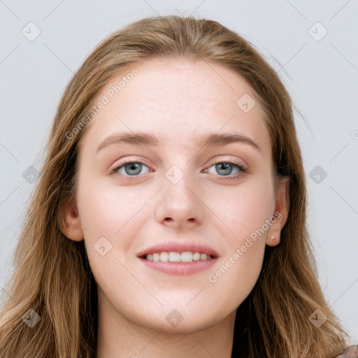 Joyful white young-adult female with long  brown hair and blue eyes