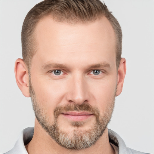 Joyful white adult male with short  brown hair and grey eyes