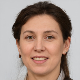 Joyful white adult female with medium  brown hair and brown eyes