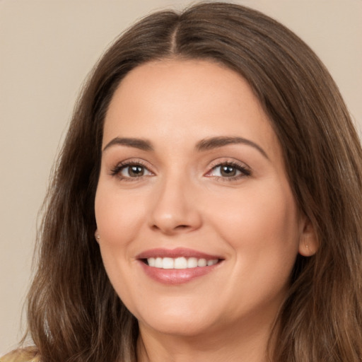 Joyful white young-adult female with long  brown hair and brown eyes