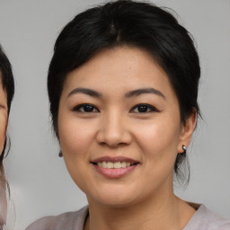 Joyful asian young-adult female with medium  brown hair and brown eyes