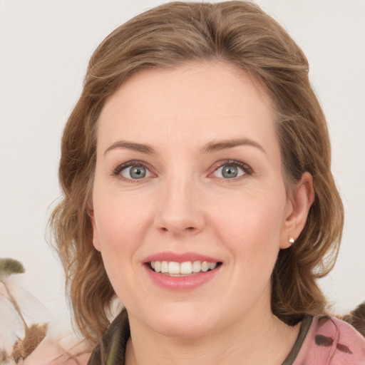 Joyful white young-adult female with medium  brown hair and green eyes