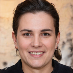 Joyful white adult female with medium  brown hair and brown eyes