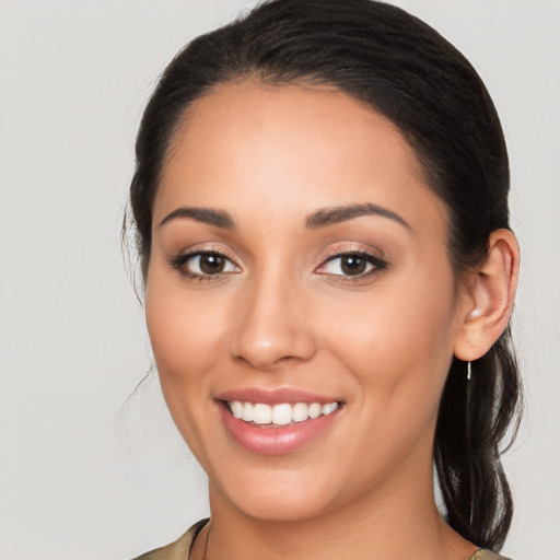 Joyful latino young-adult female with long  brown hair and brown eyes