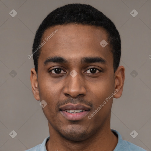 Joyful black young-adult male with short  black hair and brown eyes