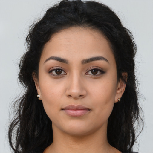 Neutral latino young-adult female with long  brown hair and brown eyes