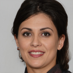 Joyful white adult female with medium  brown hair and brown eyes