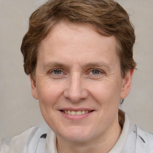 Joyful white adult female with short  brown hair and grey eyes