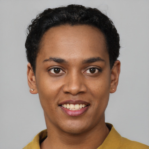 Joyful black young-adult female with short  black hair and brown eyes