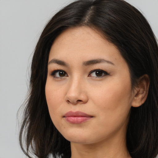 Joyful asian young-adult female with long  brown hair and brown eyes