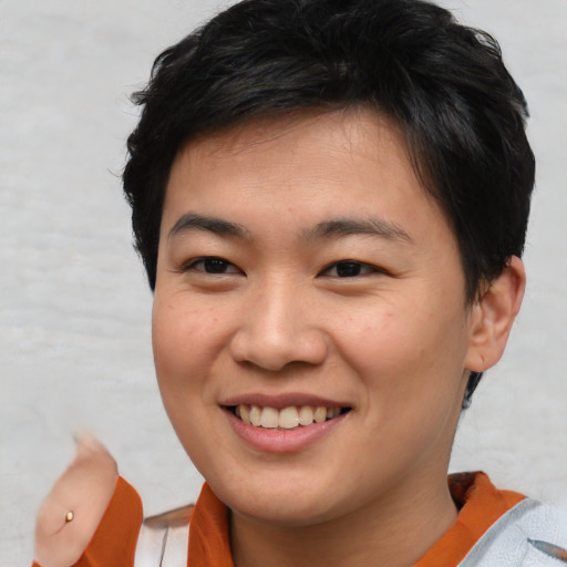 Joyful asian young-adult female with short  brown hair and brown eyes