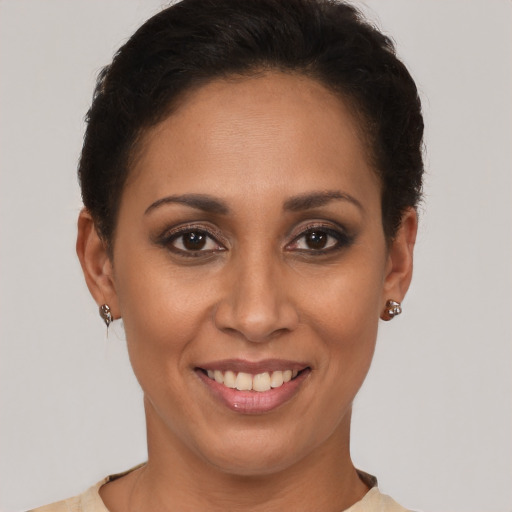 Joyful latino young-adult female with short  brown hair and brown eyes