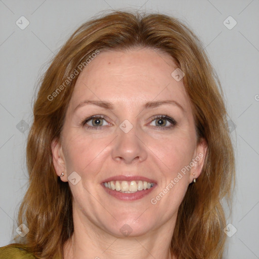 Joyful white adult female with medium  brown hair and blue eyes