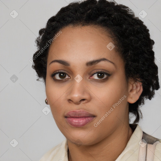 Joyful black young-adult female with short  black hair and brown eyes