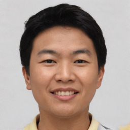 Joyful asian young-adult male with short  black hair and brown eyes