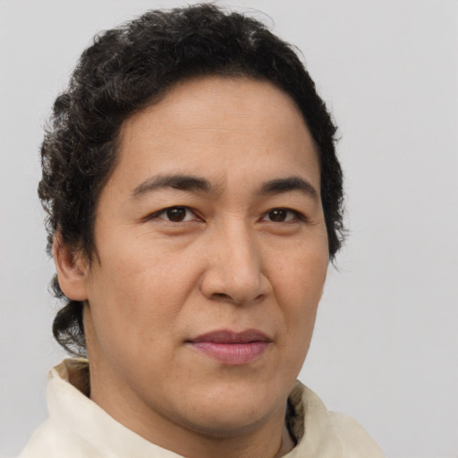 Joyful latino adult male with short  brown hair and brown eyes