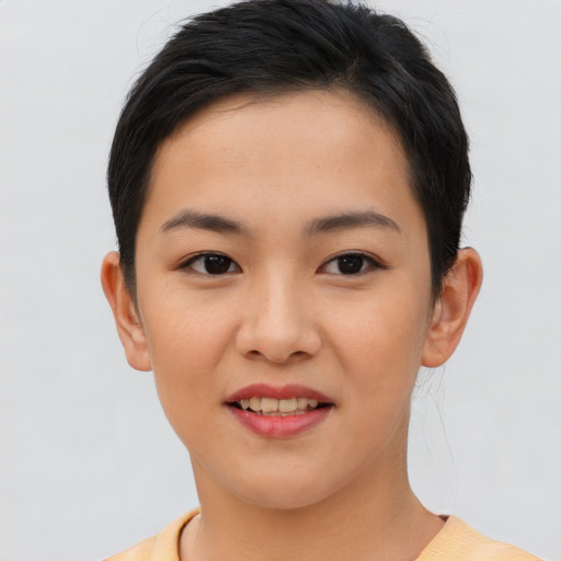 Joyful asian young-adult female with short  brown hair and brown eyes