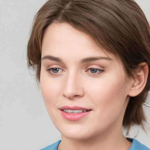 Joyful white young-adult female with medium  brown hair and blue eyes