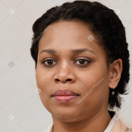 Joyful black young-adult female with short  brown hair and brown eyes