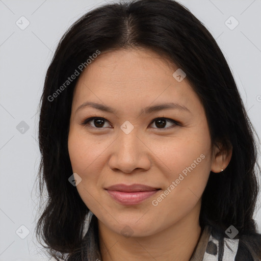 Joyful latino young-adult female with long  brown hair and brown eyes