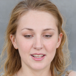 Joyful white young-adult female with medium  brown hair and blue eyes