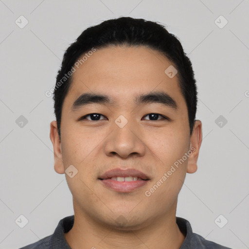 Joyful asian young-adult male with short  black hair and brown eyes