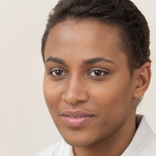 Joyful black young-adult female with short  brown hair and brown eyes