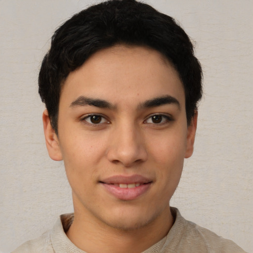 Joyful latino young-adult male with short  brown hair and brown eyes