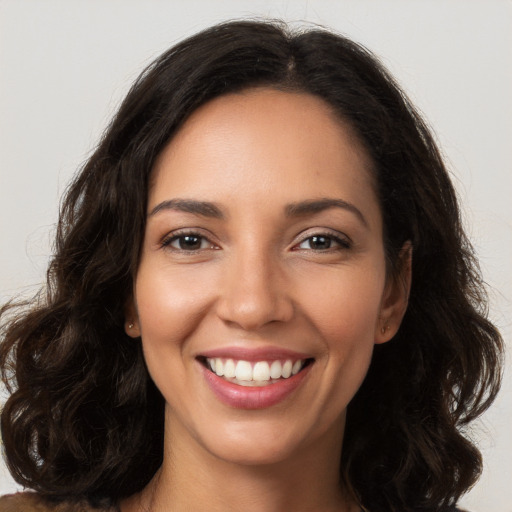 Joyful white young-adult female with long  brown hair and brown eyes