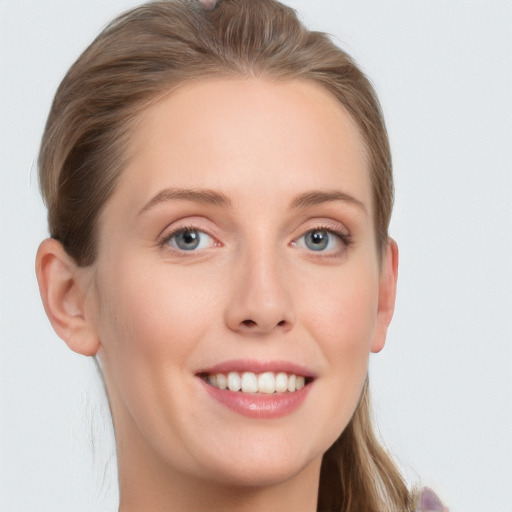 Joyful white young-adult female with long  brown hair and grey eyes