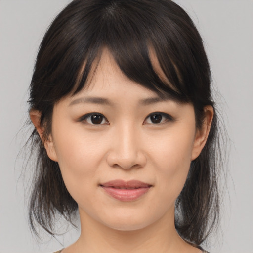Joyful asian young-adult female with medium  brown hair and brown eyes