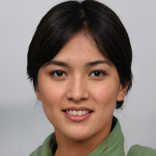 Joyful asian young-adult female with medium  brown hair and brown eyes