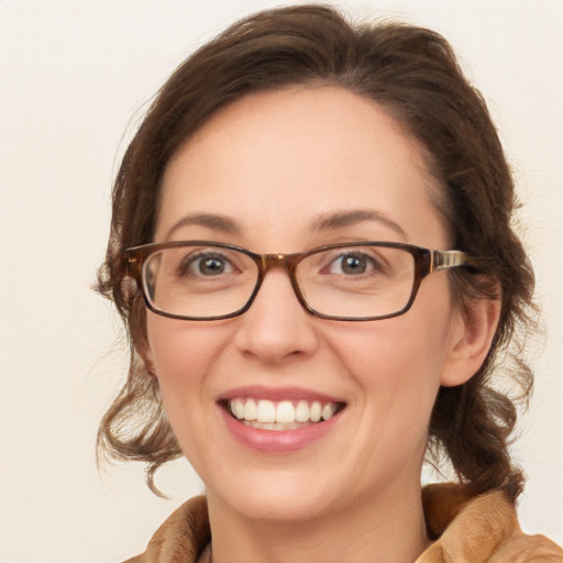 Joyful white young-adult female with medium  brown hair and blue eyes