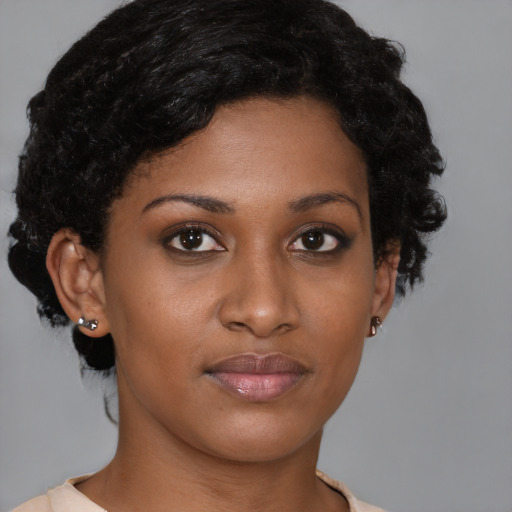 Joyful black young-adult female with short  brown hair and brown eyes