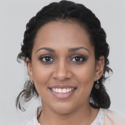 Joyful black young-adult female with medium  black hair and brown eyes