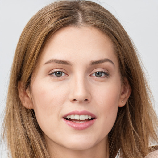 Joyful white young-adult female with long  brown hair and grey eyes