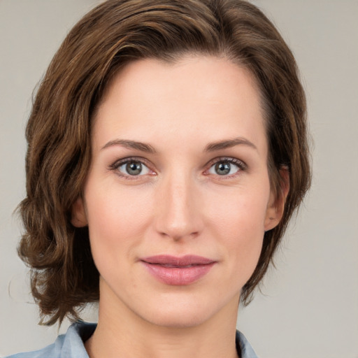 Joyful white young-adult female with medium  brown hair and green eyes