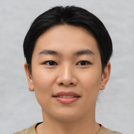 Joyful asian young-adult female with short  black hair and brown eyes