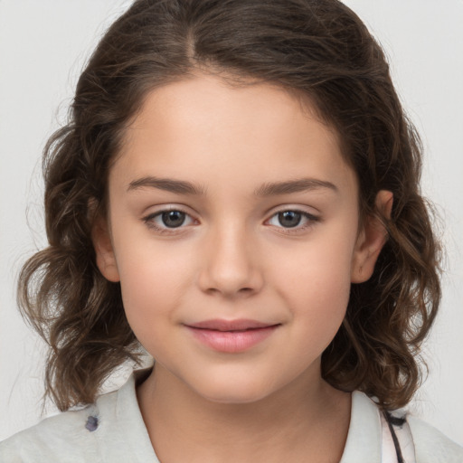 Joyful white child female with medium  brown hair and brown eyes