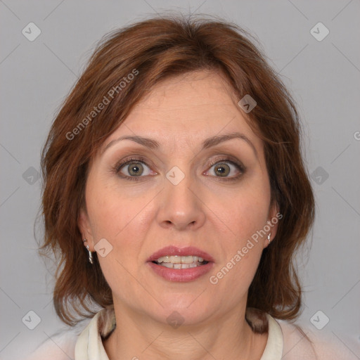 Joyful white adult female with medium  brown hair and blue eyes