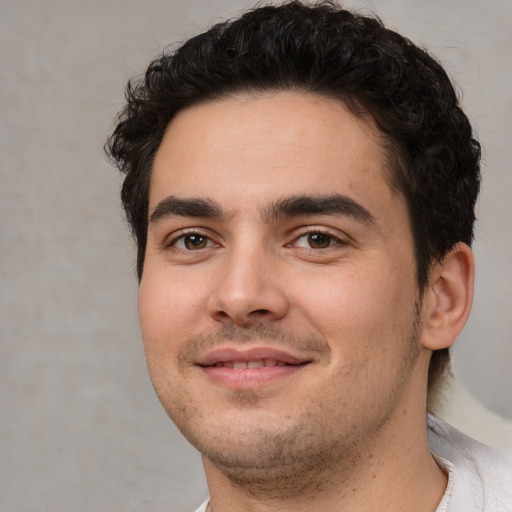 Joyful white young-adult male with short  black hair and brown eyes